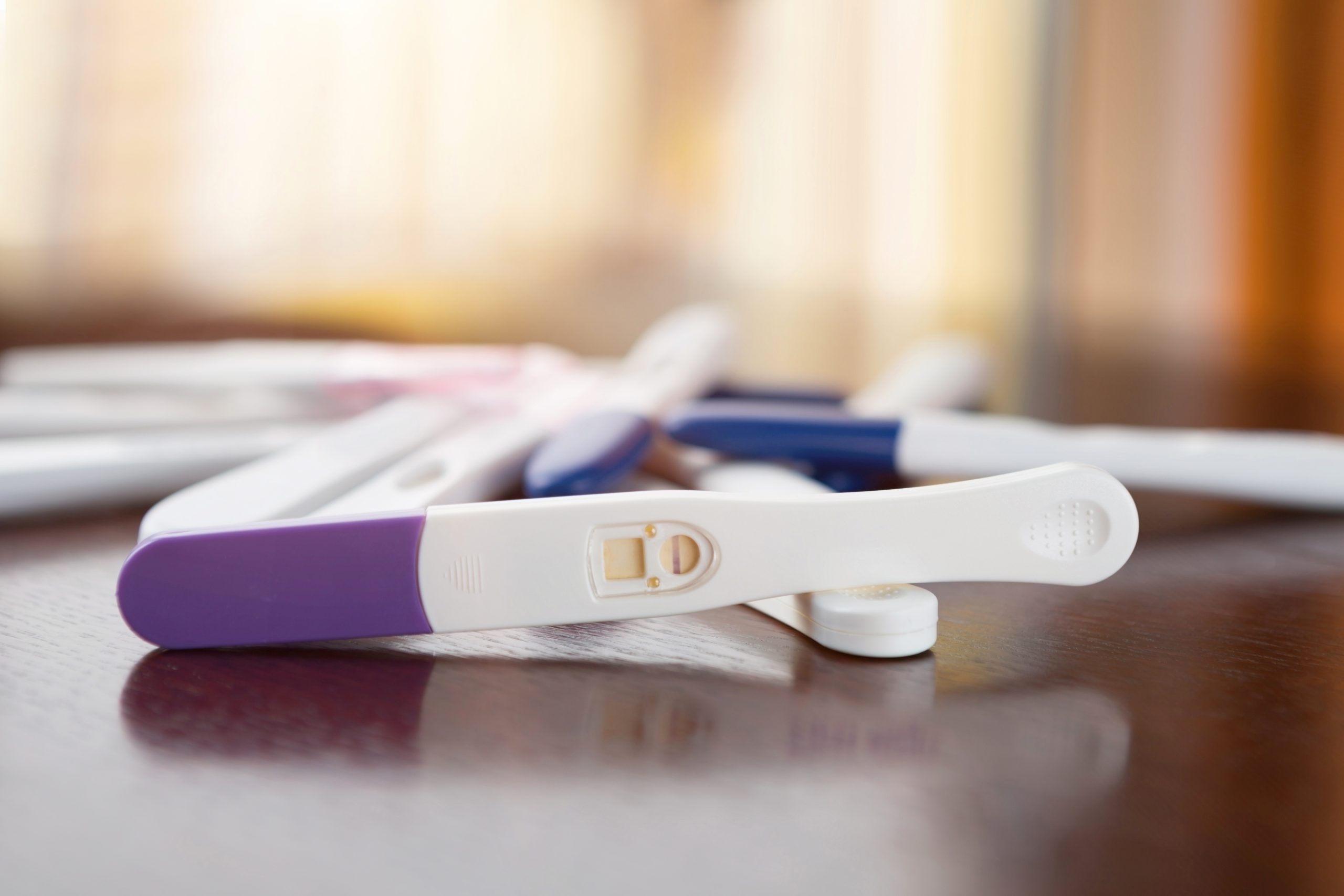 3 pregnancy tests on a counter